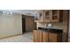 A large kitchen with wood cabinets, black countertops, and tile flooring at 1586 S Lawther Dr, Apache Junction, AZ 85120