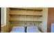 Well-equipped laundry area features plenty of shelving and a modern washer and dryer at 1586 S Lawther Dr, Apache Junction, AZ 85120