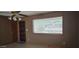 A cozy living room with tile flooring, a ceiling fan, and a large window for ample sunlight at 1586 S Lawther Dr, Apache Junction, AZ 85120