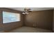 Living room featuring a fan, large window, neutral tones and tile flooring at 1586 S Lawther Dr, Apache Junction, AZ 85120