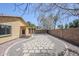 A serene backyard with a stone path, gravel, and a covered patio off the rear of the home at 16159 W Maui Ln, Surprise, AZ 85379