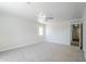 Spacious bedroom with a ceiling fan, neutral carpet, and a window offering ample natural light at 16159 W Maui Ln, Surprise, AZ 85379