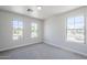 This is a bright bedroom with three large windows overlooking the neighborhood at 16159 W Maui Ln, Surprise, AZ 85379