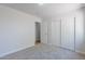Bedroom featuring fresh paint, carpet, a closet, and a doorway leading to another room at 16159 W Maui Ln, Surprise, AZ 85379