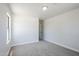 Inviting bedroom featuring neutral walls, plush carpet, and ample natural light through a large window at 16159 W Maui Ln, Surprise, AZ 85379