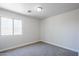 Comfortable carpeted bedroom featuring a window, a fresh paint job, and ample space at 16159 W Maui Ln, Surprise, AZ 85379
