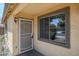 Inviting front entrance featuring a secure screen door and a window allowing natural light to brighten the doorway at 16159 W Maui Ln, Surprise, AZ 85379
