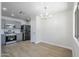 This is a spacious kitchen with gray cabinets, stainless steel appliances, and a modern chandelier at 16159 W Maui Ln, Surprise, AZ 85379