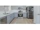 This is a kitchen featuring stainless steel appliances, light gray cabinetry, and durable flooring at 16159 W Maui Ln, Surprise, AZ 85379