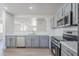 Modern kitchen with stainless steel appliances, gray cabinetry, and stylish countertops, perfect for cooking at 16159 W Maui Ln, Surprise, AZ 85379
