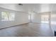 Open living area with wood floors, natural light from large windows, and sliding doors to backyard at 16159 W Maui Ln, Surprise, AZ 85379