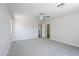 Spacious main bedroom featuring ceiling fan, carpet flooring, and large closet for a relaxing retreat at 16159 W Maui Ln, Surprise, AZ 85379