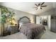 Cozy bedroom showcasing a plush bed, ceiling fan, neutral tones, and ample natural light at 16202 N 61St Ave, Glendale, AZ 85306