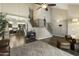 Open living area with staircase, wood flooring, stylish decor, and modern lighting fixtures at 16202 N 61St Ave, Glendale, AZ 85306
