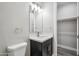 Modern bathroom featuring a sleek vanity, bright lighting, and a spacious closet at 1712 E Joelle Dr, Casa Grande, AZ 85122