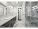 Bathroom with marble floors, dual sinks, and a glass enclosed shower with tile surround at 1712 E Joelle Dr, Casa Grande, AZ 85122