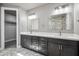This bathroom features a double vanity, gorgeous stone tile, and modern fixtures at 1712 E Joelle Dr, Casa Grande, AZ 85122