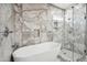Luxurious bathroom featuring tile surround, glass shower and soaking tub, and built in shelving at 1712 E Joelle Dr, Casa Grande, AZ 85122