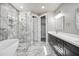 Beautiful bathroom features marble-look tile, soaking tub, and glass shower with double vanity sinks at 1712 E Joelle Dr, Casa Grande, AZ 85122
