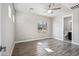 Bright bedroom features wood floors, a ceiling fan, and an attached bathroom at 1712 E Joelle Dr, Casa Grande, AZ 85122