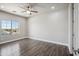 Neutral bedroom with wood-look tile flooring and a sunlit window at 1712 E Joelle Dr, Casa Grande, AZ 85122