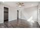 Spacious bedroom with wood-look tile floors, ceiling fan and neutral paint at 1712 E Joelle Dr, Casa Grande, AZ 85122