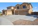 Two-story house with desert landscaping, a three-car garage, and neutral colored stucco at 1712 E Joelle Dr, Casa Grande, AZ 85122
