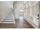 Grand foyer with high ceilings, modern staircase, and custom wall decor at 1712 E Joelle Dr, Casa Grande, AZ 85122