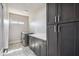 Laundry room with gray cabinets, countertop, and stainless steel washer and dryer at 1712 E Joelle Dr, Casa Grande, AZ 85122