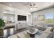 Bright living room featuring modern furnishings, ceiling fan and backyard views at 1712 E Joelle Dr, Casa Grande, AZ 85122