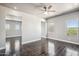 Spacious living room with wood-look tile flooring, ceiling fan and backyard views at 1712 E Joelle Dr, Casa Grande, AZ 85122