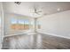 Spacious living room features wood-look tile flooring, neutral paint, and large windows offering lots of natural light at 1712 E Joelle Dr, Casa Grande, AZ 85122