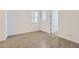 Sunlit bedroom featuring stylish wood-look tile flooring and neutral walls at 17557 W Victory St, Goodyear, AZ 85338