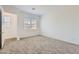 Inviting bedroom with plush carpeting, bright natural light, and neutral decor at 17557 W Victory St, Goodyear, AZ 85338