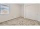 Neutral bedroom featuring a large window, blinds, and sliding-door closet at 17557 W Victory St, Goodyear, AZ 85338