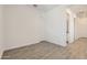 Large bedroom with wood-look tile floors and neutral paint, offering a serene atmosphere at 17557 W Victory St, Goodyear, AZ 85338