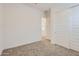 Bedroom boasting neutral colors, sliding closet doors, and plush carpeting at 17557 W Victory St, Goodyear, AZ 85338