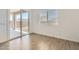 Bright bedroom with tile flooring, large sliding glass door and a window with blinds at 17557 W Victory St, Goodyear, AZ 85338