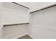 Bright walk-in closet featuring wooden rods and white shelving, maximizing space at 17557 W Victory St, Goodyear, AZ 85338