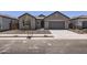 Charming single-story home with a two-car garage, desert landscaping, and neutral color palette at 17557 W Victory St, Goodyear, AZ 85338