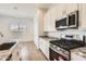 Close-up of kitchen with stainless steel appliances, granite countertops, and a bright breakfast area at 17557 W Victory St, Goodyear, AZ 85338