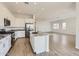 Modern kitchen with white cabinets, granite countertops, stainless steel appliances, and an island at 17557 W Victory St, Goodyear, AZ 85338