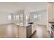 Bright kitchen with an island, stainless steel appliances, and a large open-concept living space at 17557 W Victory St, Goodyear, AZ 85338
