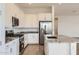 Modern kitchen showcasing granite countertops, stainless steel appliances, and sleek white cabinetry at 17557 W Victory St, Goodyear, AZ 85338