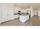 Bright kitchen features an island, granite countertops, stainless steel appliances, and wood-look tile flooring at 17557 W Victory St, Goodyear, AZ 85338