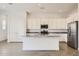 Spacious kitchen with stainless steel appliances, granite countertops, and an open layout at 17557 W Victory St, Goodyear, AZ 85338