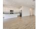 Bright kitchen with white cabinetry, stainless steel appliances, and a view into the expansive living space at 17557 W Victory St, Goodyear, AZ 85338