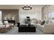 Open-concept living room with stylish furnishings and seamlessly connected to the kitchen at 17557 W Victory St, Goodyear, AZ 85338