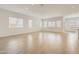 Large open-concept living area with tile floors, bright lighting, and lots of windows at 17557 W Victory St, Goodyear, AZ 85338