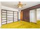 Bedroom featuring retro carpet, open closet, ceiling fan, and open doorway at 1810 N 74Th St, Scottsdale, AZ 85257